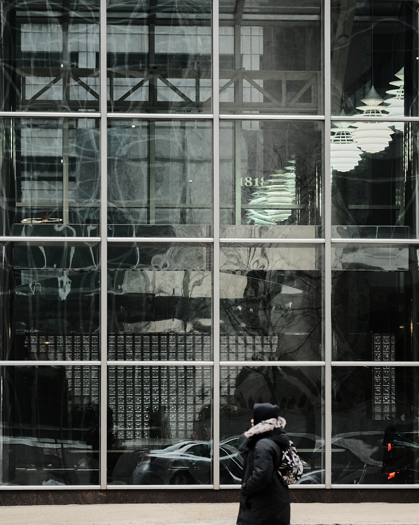 Woman walking by windows.